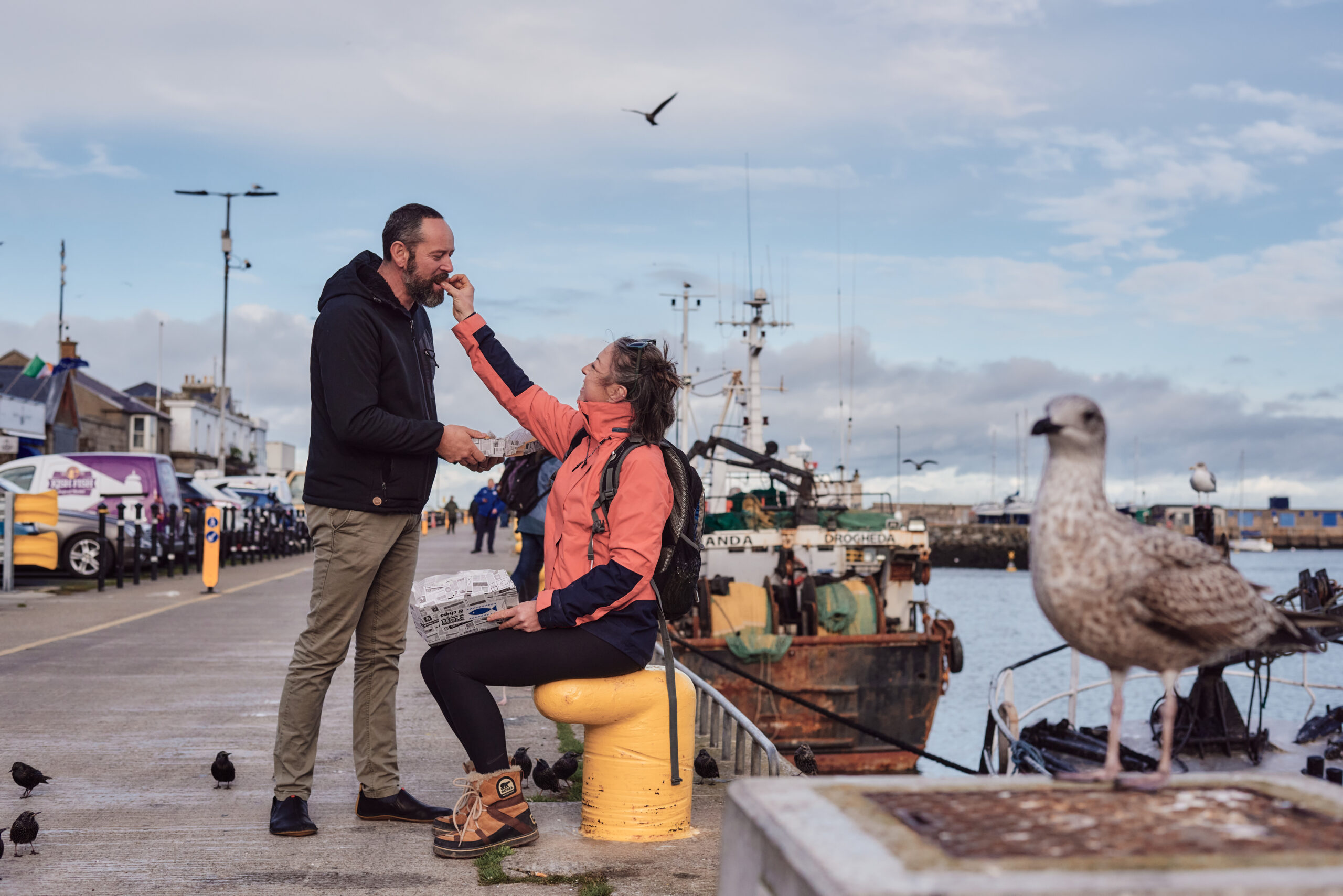 Couple of middle age people eating in Howth Pier