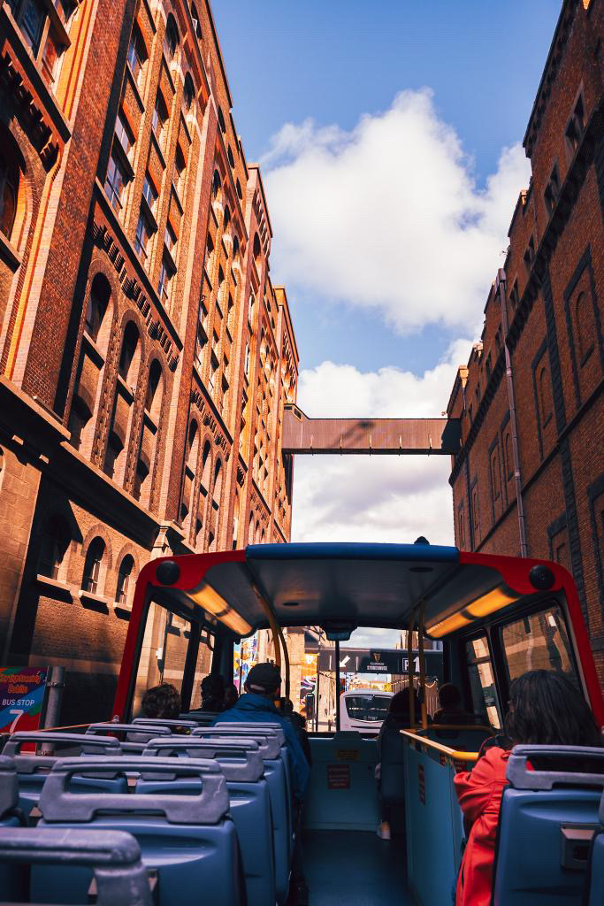 open roof double decker bus view of dublin city buildings